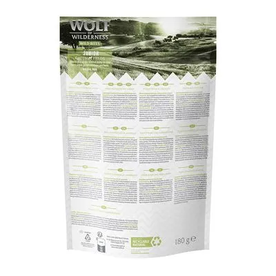 Wolf of Wilderness Wild Bites Junior Green Fields, sachet de 180 g vu de dos avec informations multilingues et mention « Recyclable Material » visible en bas.