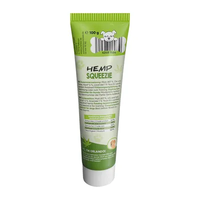 Tubo da 100 g di Hemp Squeezie per cani, con tabella analitica: proteine grezze 4,1 %, oli e grassi grezzi 12,6 %, fibre grezze 0,8 %, umidità 12,2 %. Testo in inglese e tedesco.