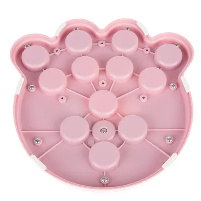 Pink plastic toy in paw shape with several round elements and screws. 'Made in China' inscription visible.