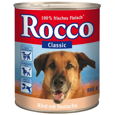 Rocco Classic 800 g blik, 100% frisches Fleisch, rund met seelachs. Tekst: ondersteunt goede vertering, glanzend vacht, kracht & energie. Tekst deels in het Duits.