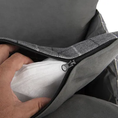 Close-up of a grey zip showing a removable inner cushion with white mesh material.