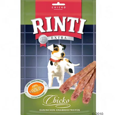 Opakowanie Rinti Extra Chicko z wizerunkiem psa, widoczne paski suszonego mięsa. Tekst: 100% Kaninchen, Ohne Fleischmehle, Chicko, Kaninchen-Knabberstreifen.