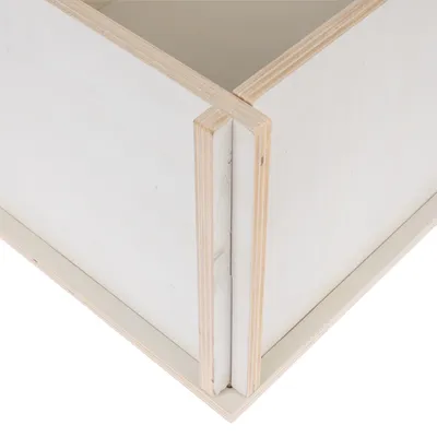 Detailed view of a wooden structure with light plywood panels and precise joints.