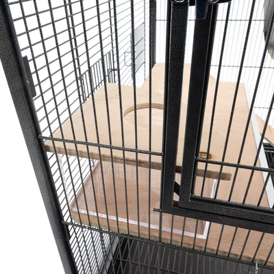 Bird cage with metal grid walls and wooden platform with round opening, suitable for birds to sit or play.