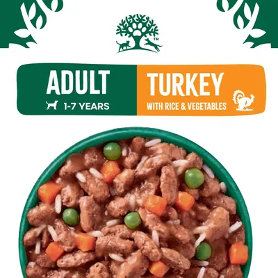 Adult pet food for ages 1-7 years, turkey with rice and vegetables. Image shows bowl containing chunks of meat, peas, carrots, and rice.