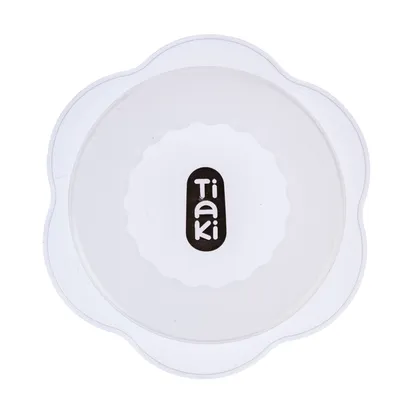 Tiaki. White lid with wavy edge and black logo in the centre.