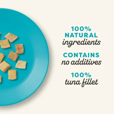 100% natural ingredients, contains no additives, 100% tuna fillet. Image shows small food pieces on a blue plate.