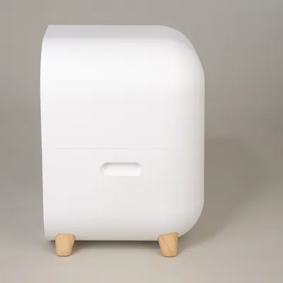 White container with rounded corners and wooden feet, side handle opening visible.