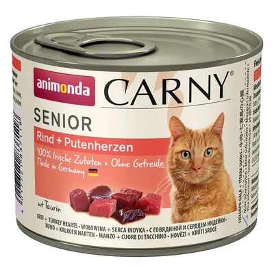 Animonda Carny Senior говядина и сердечки индейки, 100% свежие ингредиенты, без зерна, Made in Germany, с таурином. Банка с красной этикеткой и изображением оранжевой кошки.
