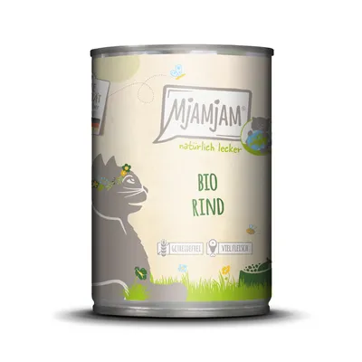 MjAMjAM Bio wołowina, naturalnie smaczna. Bez zbóż, dużo mięsa. Ilustracja kota z kwiatowym wieńcem na zielonym tle.