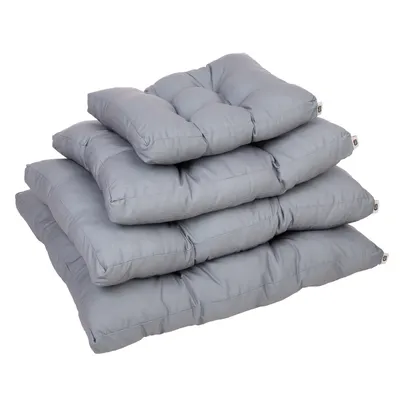 Quatre coussins gris pour animaux, empilés par taille croissante, étiquette visible sur le côté de chaque coussin. Matière textile rembourrée.