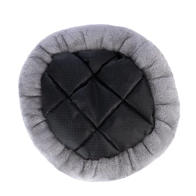 Cama redonda gris para mascotas con superficie de descanso negra acolchada y base antideslizante.
