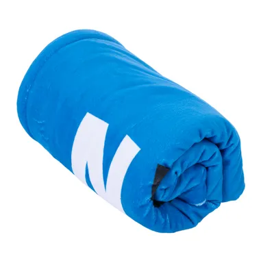Rolled-up blue blanket with white letter 'N' visible on the surface.