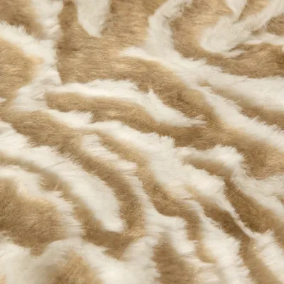 Detail van beige-witte pluche stof met golvend patroon, zichtbaar materiaal voor huisdierbed of deken.
