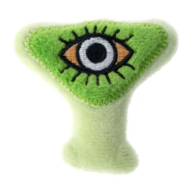 Jouet en peluche vert en forme triangulaire avec un œil brodé noir, blanc et orange au centre. Matière textile douce visible.