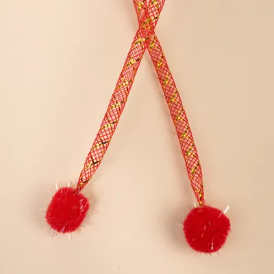 Net toy with red and gold accents, two red plush balls at the ends.