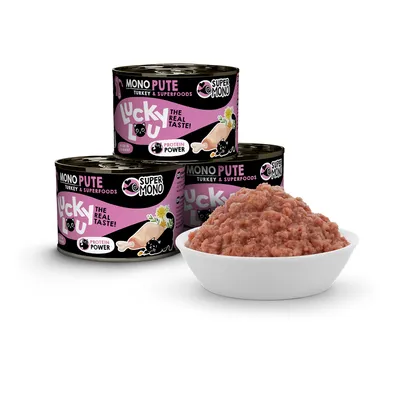 Lucky Lou Mono Pute Turkey & Superfoods. Protein Power. Three cans of cat food and a bowl with served wet food.
