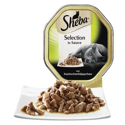 Sheba Selection in Sauce mit Kaninchenhäppchen kattenvoer, stukjes vlees in saus op een wit bord, verpakking met merknaam en afbeelding van een kat zichtbaar.