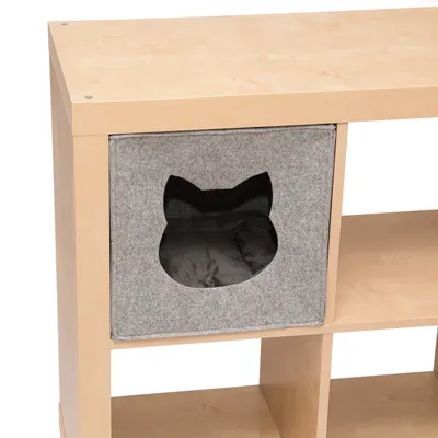 Grey felt box with cat head cut-out, integrated into a wooden shelf. Interior padded with black cushion.