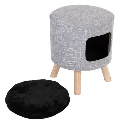 Runder grauer Hocker mit Holzbeinen und integriertem Höhlenfach, inklusive schwarzem abnehmbarem Kissen.