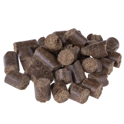 Brown, cylindrical treat pieces made from compressed material, suitable for feeding or rewarding pets.