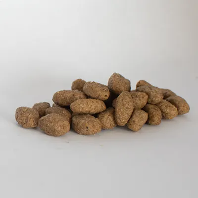 Pile of dry pet food kibble pieces shown on a plain background, displaying the size and shape of the product.