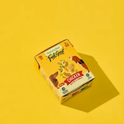 Naturediet Feel Good Chicken with rice and carrots, 390g. Shows product box with illustrations of ingredients and animals. Label states natural ingredients and grain free.