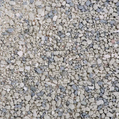 Κοντινή εικόνα ανοιχτόχρωμων και γκρι κόκκων άμμου, χωρίς ορατή συσκευασία ή επωνυμία. Το προϊόν εμφανίζεται σε μορφή χύδην.