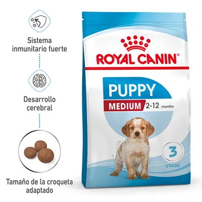 Royal Canin Puppy Medium 2-12 months. Sistema inmunitario fuerte, desarrollo cerebral, tamaño de la croqueta adaptado. Imagen del envase y croquetas redondas visibles.