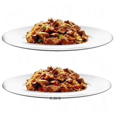 Two white plates each with chunks of brown wet pet food and visible vegetable pieces, shown on a plain background. No brand or packaging visible.