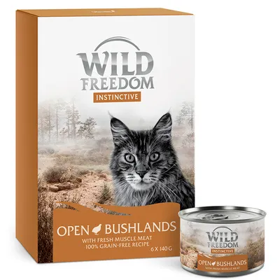 Boîte et conserve Wild Freedom Instinctive Open Bushlands, avec image de chat, mention 'with fresh muscle meat', '100% grain-free recipe', lot de 6 x 140 g visibles sur l'emballage.