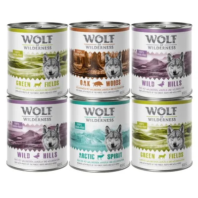 Sześć puszek Wolf of Wilderness: Green Fields, Oak Woods, Wild Hills, Arctic Spirit. Widoczne napisy 100% grain-free, każda puszka 800 g.