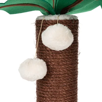 Scratching post made of brown sisal with two white plush balls on strings and green felt leaves on top.