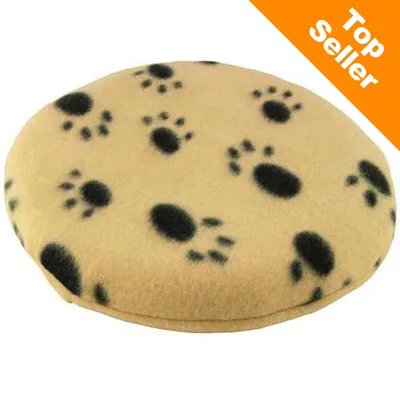 Rund pude i beige stof med sorte poteaftryk. Øverst til højre ses teksten 'Top Seller' på orange baggrund. Rund pude i beige stof med sorte poteaftryk. Øverst til højre ses teksten 'Top Seller' på orange baggrund.