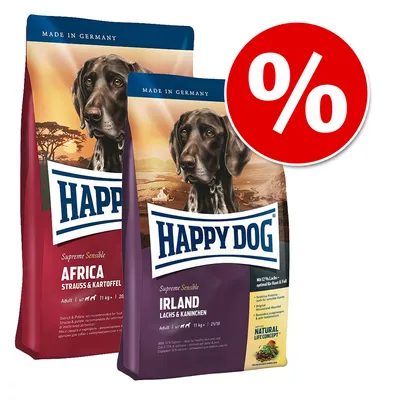 Två förpackningar Happy Dog hundfoder: Africa Strauss & Kartoffel och Irland Lachs & Kaninchen. Röd cirkel med procenttecken visar erbjudande eller rabatt.