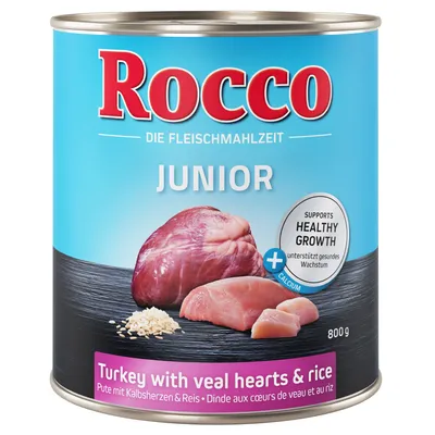 Lata de Rocco Junior, 800 g, con imágenes de corazón de ternera, pavo y arroz. Texto visible: 'Supports healthy growth', 'Turkey with veal hearts & rice', '+ calcium'.