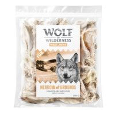 Sachet de friandises Wolf of Wilderness Wild Chews, texte visible : Meadow Grounds Rabbit Ears Without Fur, 200 g. Emballage transparent montrant les oreilles de lapin.