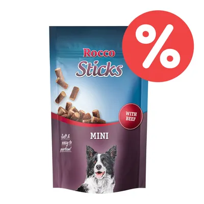Rocco Sticks Mini mit Rind, weiche und leicht zu portionierende Snacks. Verpackung zeigt einen Hund und ein Prozentzeichen für Rabatt. Rocco Sticks Mini mit Rind, weiche und leicht zu portionierende Snacks. Verpackung zeigt einen Hund und ein Prozentzeichen für Rabatt.