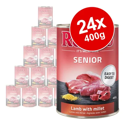 Rocco Senior Lamb with millet, Easy to Digest, 24 x 400g tins. Large tin in front, stack of tins behind. Visible text: IT'S MEAT TIME, SENIOR, Lamb with millet, 400g.