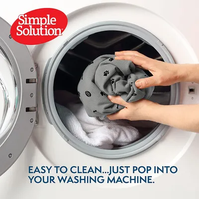 Simple Solution product, easy to clean. Fabric with paw print pattern placed in a washing machine.