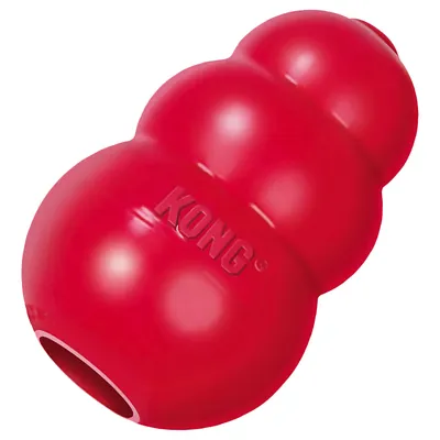 Giocattolo KONG rosso in materiale resistente con forma caratteristica e apertura per il riempimento. Marchio 'KONG' visibile sulla superficie. Giocattolo KONG rosso in materiale resistente con forma caratteristica e apertura per il riempimento. Marchio 'KONG' visibile sulla superficie.