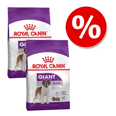 Dwie torby karmy Royal Canin Giant Adult z widocznym psem na opakowaniu, obok czerwone kółko z białym symbolem procenta, sugerujące promocję lub ofertę specjalną.