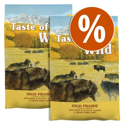 Dos sacos de Taste of the Wild High Prairie Canine Formula, visible texto: 'with bison & roasted venison, a grain-free diet'. Círculo naranja con símbolo de porcentaje en blanco.