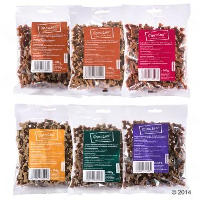 Six sachets de friandises pour chiens Chewies, 200 g chacun, étiquettes de couleurs différentes avec texte visible en plusieurs langues et codes-barres.