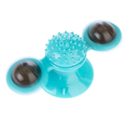 Turquoise speelgoed met zuignap, roterende ballen en stekelige oppervlakte in het midden.