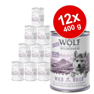 Zestaw 12 puszek Wolf of Wilderness Little Wild Hills Junior, każda 400 g. Widoczny napis: 100% grain-free. Na etykiecie obrazek szczeniaka i góry.
