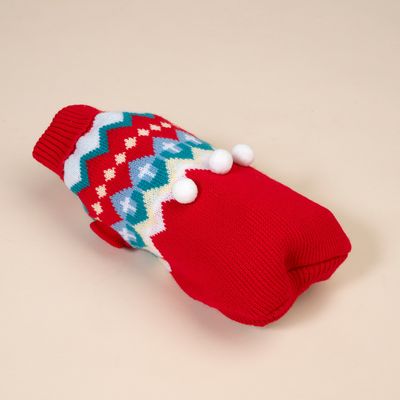 Red knitted dog jumper with colourful zigzag pattern and three white pom-poms, suitable for cold days.