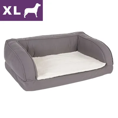 Legowisko dla psa, rozmiar XL, szare boki z białym miękkim wnętrzem. Widoczny symbol psa i napis XL w lewym górnym rogu.
