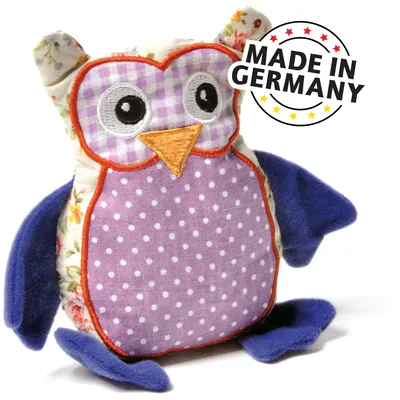 Blago sova z vijoličnimi pikami, modrimi krili in oranžnim kljunom. Besedilo: Made in Germany.