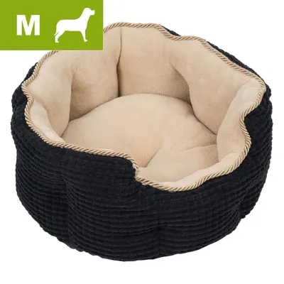 Okrągłe legowisko z beżowym wnętrzem i czarną tkaniną na zewnątrz, rozmiar M oznaczony w lewym górnym rogu zieloną ikoną psa i literą M.